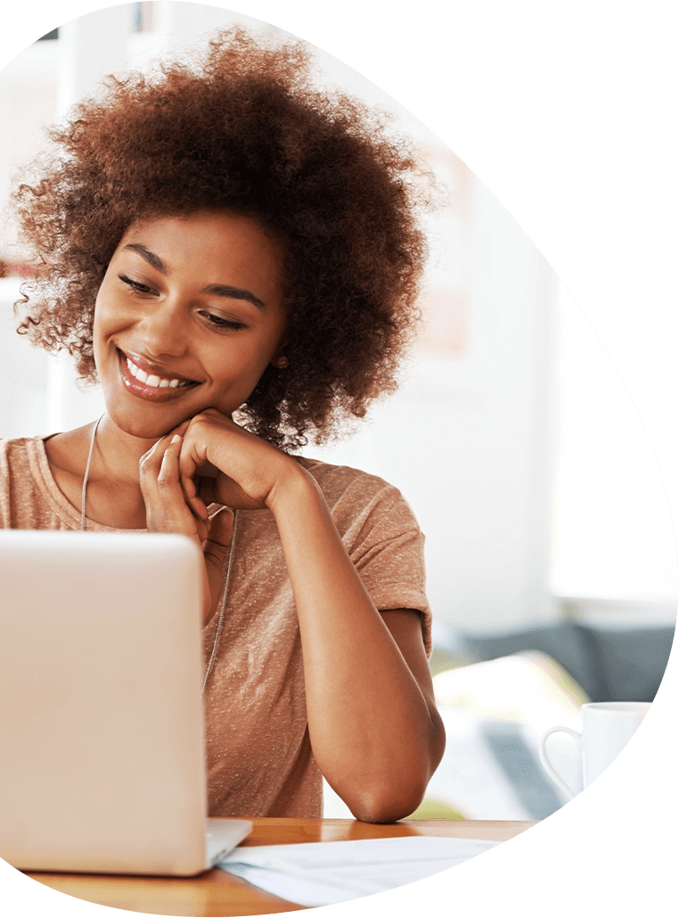 woman checking her laptop with smile