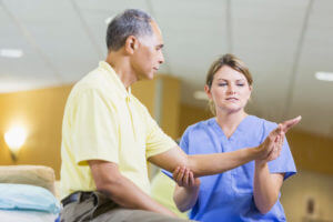 Occupational Therapist assisting senior man
