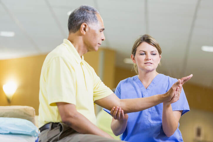Occupational Therapist assisting senior man