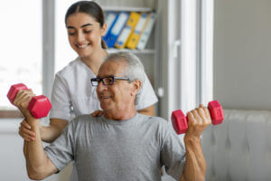 Nurse and male patient during physical therapy