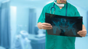Orthopedic surgeons looking at x-ray film