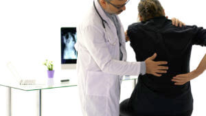 back pain specialist analysing patient back pain
