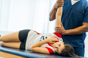 An athlete receiving rehibilitative care for a sports injury.