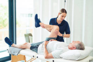 Physiotherapy doctor, senior patient and leg surgery, physical therapy and orthopedic healing. Physiotherapist, chiropractor and nurse help elderly injury, osteoporosis and arthritis rehabilitation