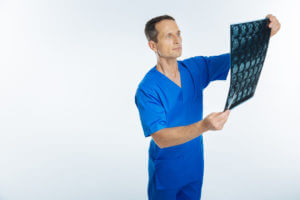 Orthopedic surgeon looking at mri scan of patient