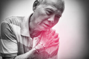 An elderly man placed his hand on his shoulder due to pain from a rotator cuff injury.